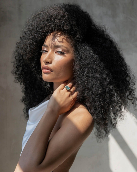 dark romance hair trend 2026 person with romantic voluminous natural curls